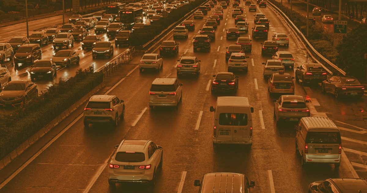 Dense multi-lane traffic on an urban motorway at dusk
